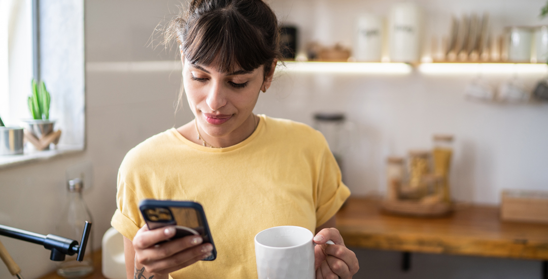 woman in her kitchen using app