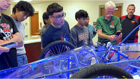 a group of STEM students assessing an electrical go kart