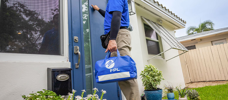 a man at door holding an FPL bag