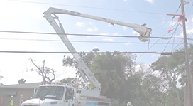 lineworker in bucket truck near power pole