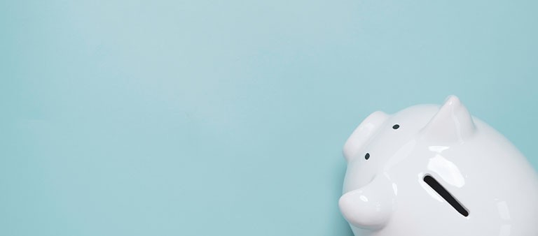Top view or flat lay of white piggy bank saving on blue background