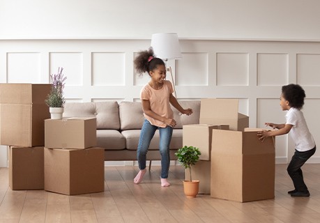 Kids playing around moving boxes